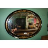 An oval bevel plated Mirror in a Japanned frame (damaged)