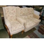 A small modern two seat Sofa in oatmeal ground floral fabric upholstery along with matching wing
