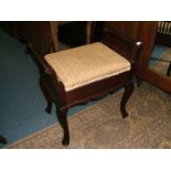 An Edwardian Mahogany framed Music Stool with floral patterned fabric seat and standing on cabriole