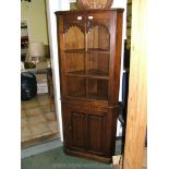 A good quality reproduction Oak Priory style two-section floor standing corner Display Cabinet