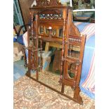 An ornate Walnut Edwardian overmantle Mirror with pierced detail, five shelves,