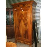 An elegant French Cherrywood Armoire having moulded cornice over a plain frieze,