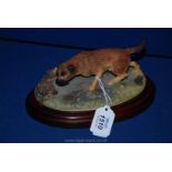 A Border Fine Arts figurine of a Terrier watching a Hedgehog.