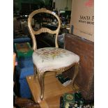 A French gilt Salon Chair with floral tapestry seat and standing on cabriole style legs.