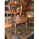 A Victorian beech hoop back solid seat Hall Chair on turned legs.