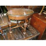 A 1940's Oak oval Occasional Table with glass cover and baluster turned legs with cross stretcher.