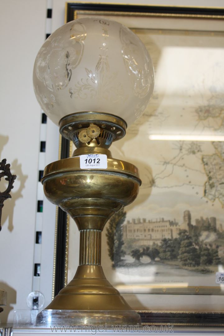 A Brass Oil Lamp with etched globe shade