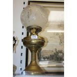 A Brass Oil Lamp with etched globe shade