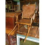 A leather upholstered Beech framed Edwardian Sedan Chair with sliding front handles and standing on