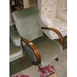 A green draylon upholstered Art Deco style Rocking Chair with swept and curved Oak arms.