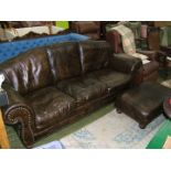 A substantial modern Brown Leather three seater Settee with brass studded/nailed scroll end arms