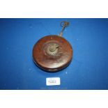 A leather cased tape measure by Hockley Abbey,