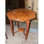 An Edwardian octagonal topped Centre Table, standing on turned legs with square lower tier.