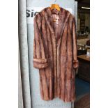 A Ladies full length brown fur coat