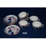 A group of 5 Staffordshire porcelain cups and saucers decorated in gaudy Welsh type colours,