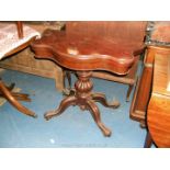 An early Victorian Mahogany serpentine fold-over Card/gaming Table, the revolving fold-over top,