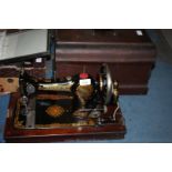 An old Jones Sewing Machine in wooden case