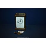 A French Brass Carriage Clock with enamelled dial,