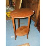 A 1930's Oak oval top two tier Occasional Table.