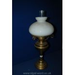 A Brass Oil Lamp with milky white glass shade and clear glass chimney,