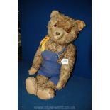 A straw filled, jointed Teddy Bear with material paw pads and sewn nose and mouth,