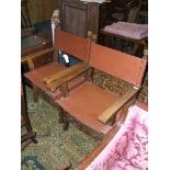 A pair of modern Baronial style Elbow Chairs with nailed brown leather upholstery,