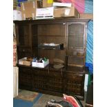 A large modern Oak finished Lounge Dresser, the top having two glazed doors,