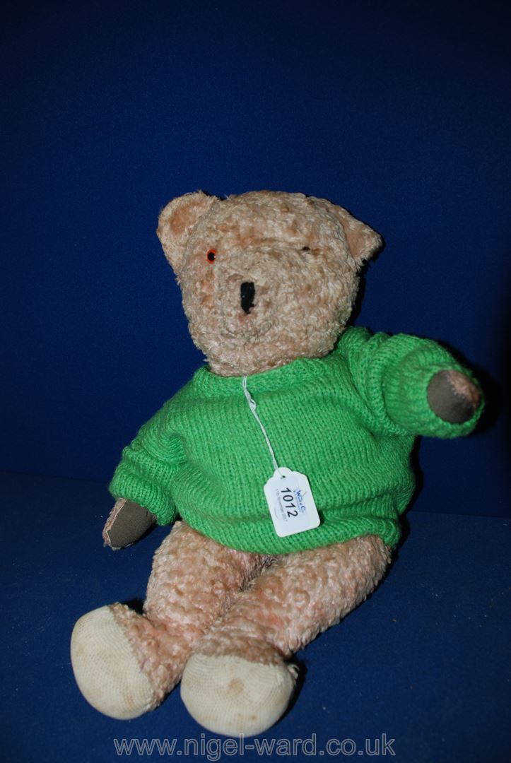 A faded pink, straw filled soft jointed Teddy Bear, replaced paw pads,