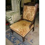 A Walnut framed Ladies Salon Easy Chair with button back in gold ground embossed velvet fabric