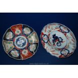 Two Japanese Imari plates and a pair of Japanese Celadon vases with raised prunus, all 19th century.