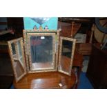 A Triptych Dressing Table Mirror with gilt leaf design