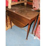 A Georgian style Mahogany oval drop-leaf Occasional Table on tapering turned legs terminating in