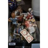 A quantity of china figures including a monk, musical miner, clowns,