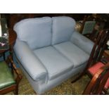 A modern small two seater Sofa with scroll arms in pale blue,