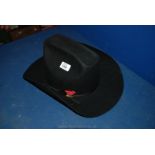 A black wool Stetson with red feather trim, size 7 1/2.