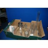 A quantity of glass measuring flasks, glass funnels, an Interval timer,