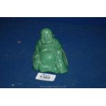 A carved green Buddha figure