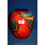A large Poole pottery Vase in reds, blue and orange colours,