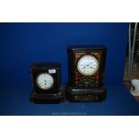 Two black wooden Clocks, one with decorated front, luc Marc in Paris, face a/f.
