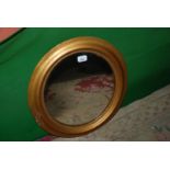 An oval Wall Mirror in gilt surround (a/f)