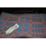 A Welsh wool Blanket in pink with green and blue geometric pattern