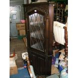 A reproduction Oak Priory style two door floor standing Corner Cupboard,