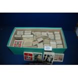 A box of Cigarette Cards in sets,