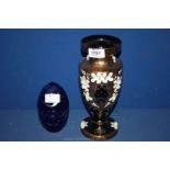 A black glass Vase with gilt ground and applied floral decoration together with a blue glass egg