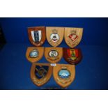 Eight Military insignia Shields mounted on plaques.