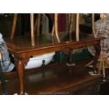 A reproduction walnut Queen Anne style lounge table with cross banded top and herringbone inlaid