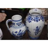 A blue and white floral Delft Vase along with a similar pattern Delft Jug