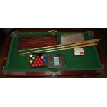 A good miniature slate bed Snooker Table and accessories, by E.J. Riley Ltd.