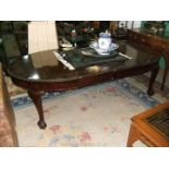 A good Mahogany Oval wind-out extending Dining Table with two extra leaves, carved edges,
