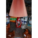 A pottery based Table Lamp, the base deep crimson ground with black,